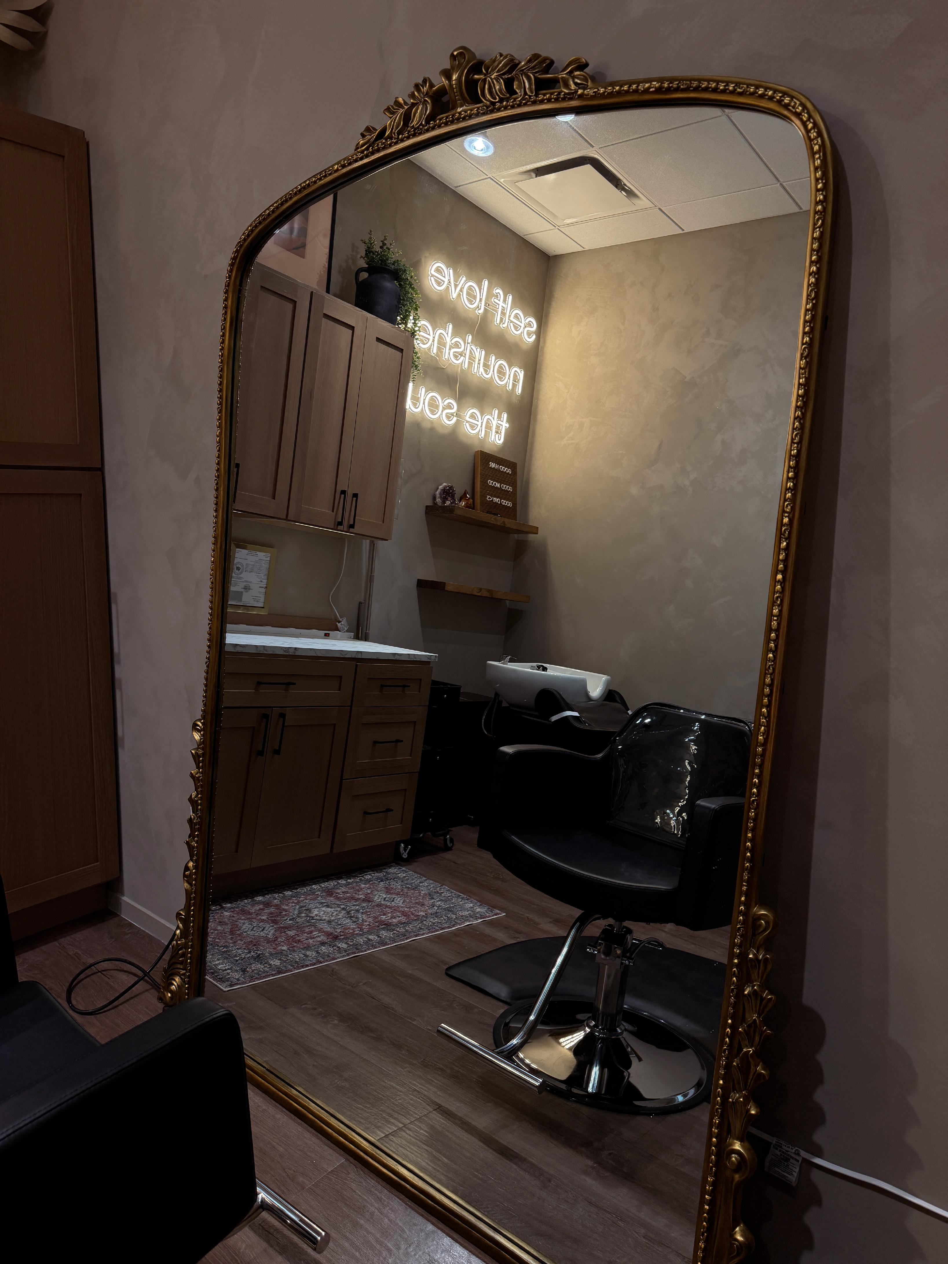 Antique gold mirror reflecting the private studio